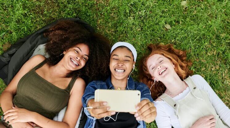 Three girls looking at iPhone