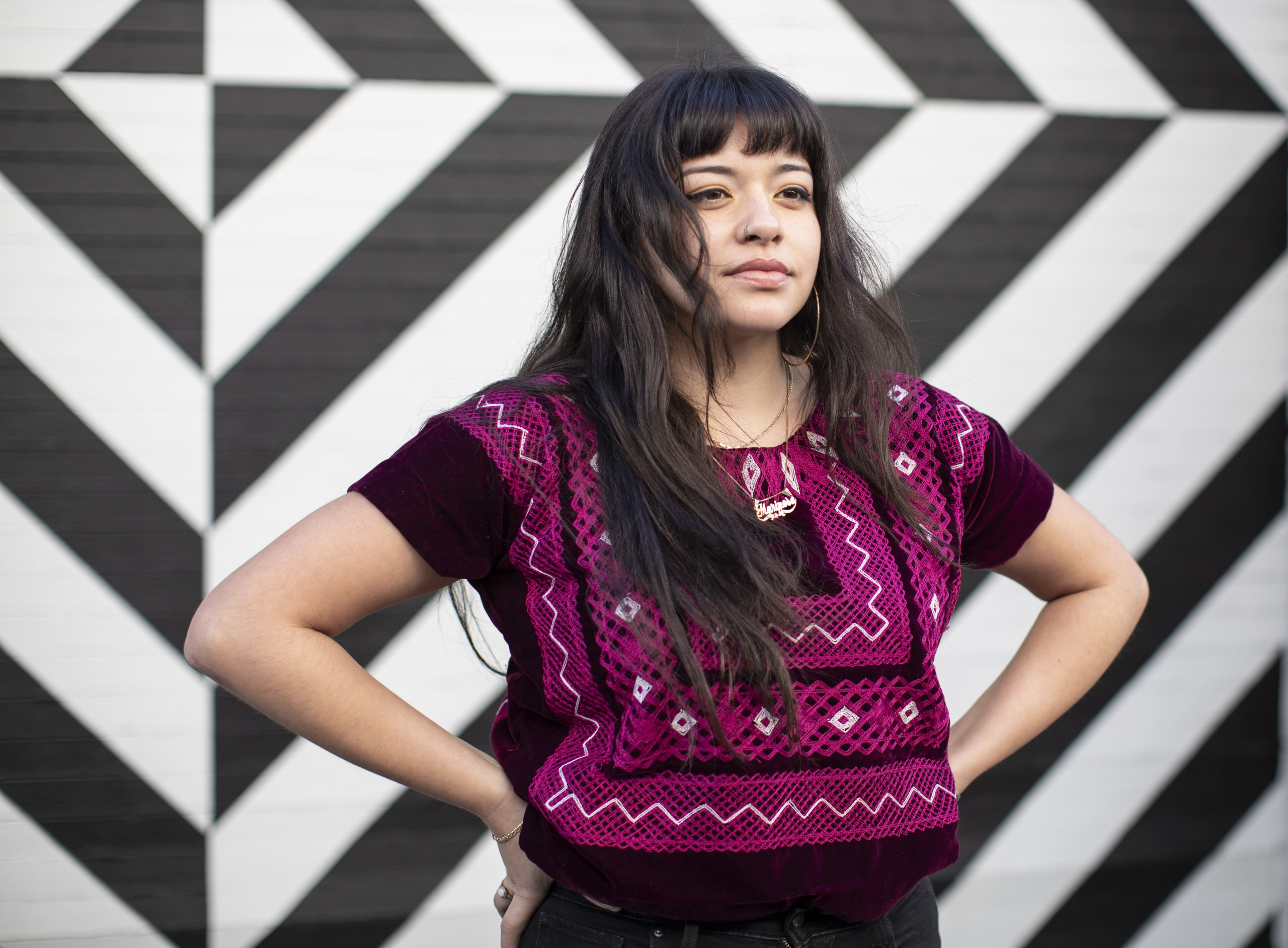 Close Up Young Latina Wears Magenta Ethnic Top, Stands Confidently with Hands on Hips, Body Positive