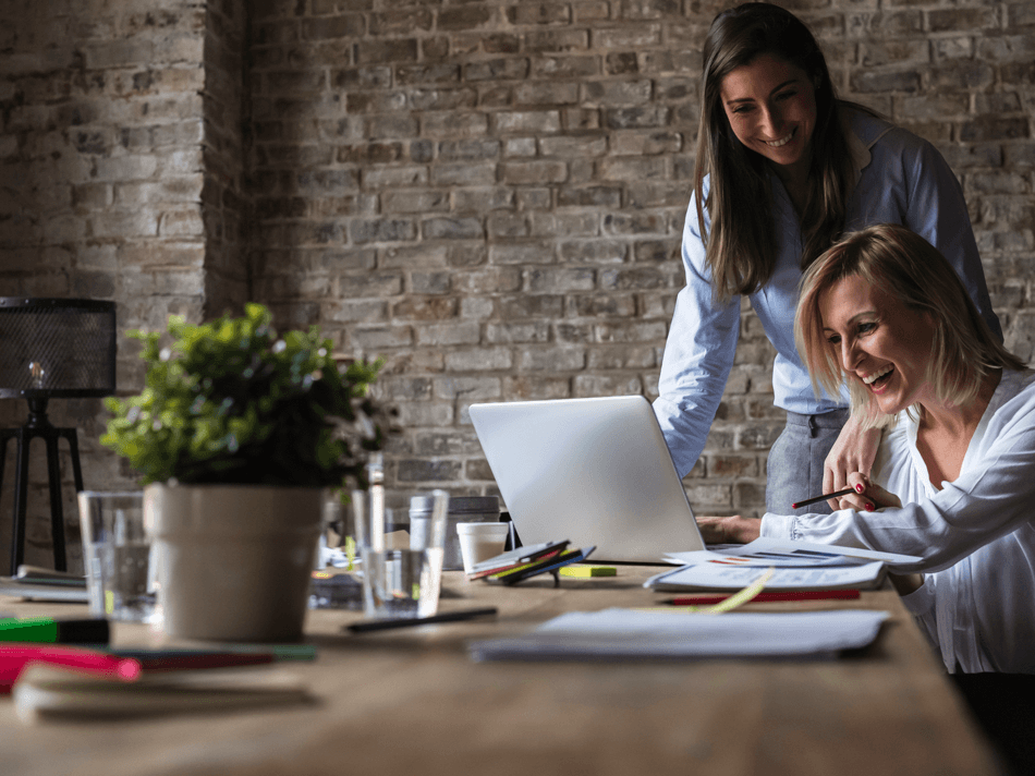 Women collaborating on laptop