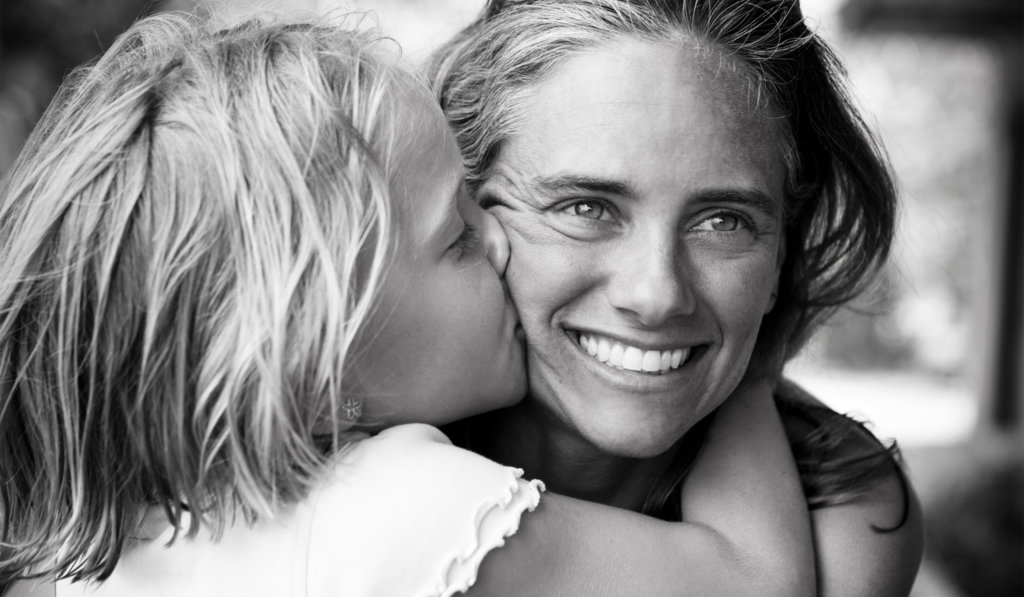 Woman being kissed by young girl